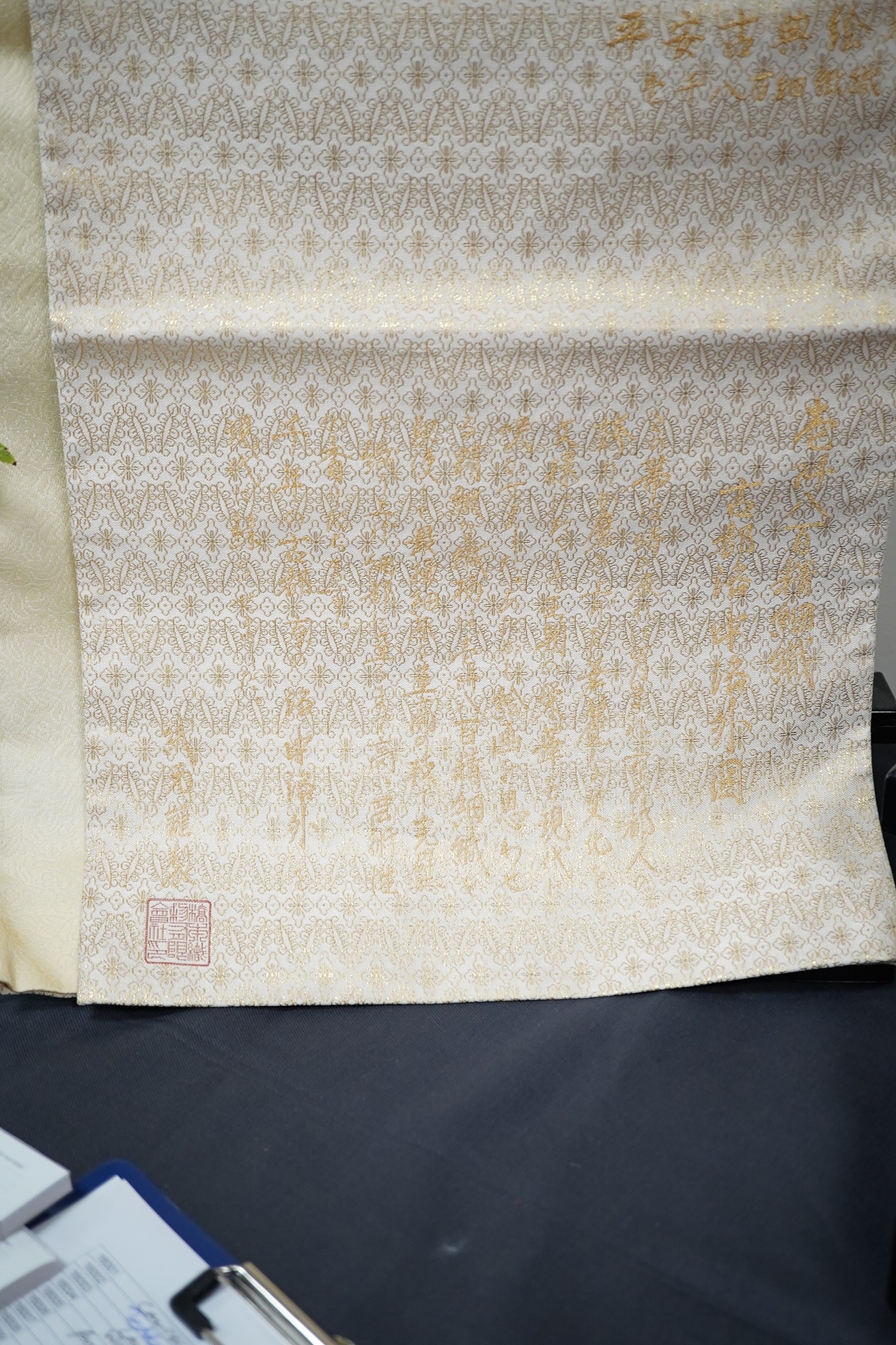 Two vintage silk brocade Obi, bought from Masae Shibamura in Tokyo with the ‘Four Seasons’ wedding kimono, one woven in gold brocade, depicting in minute detail a large celebratory procession, in two panels, the remainin